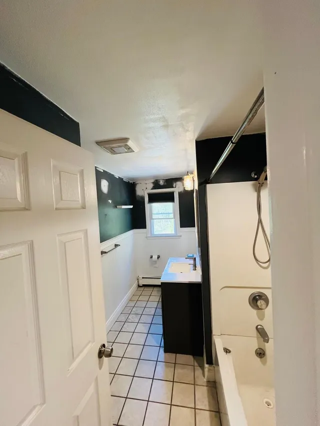 Bathroom black accent wall white doors painting