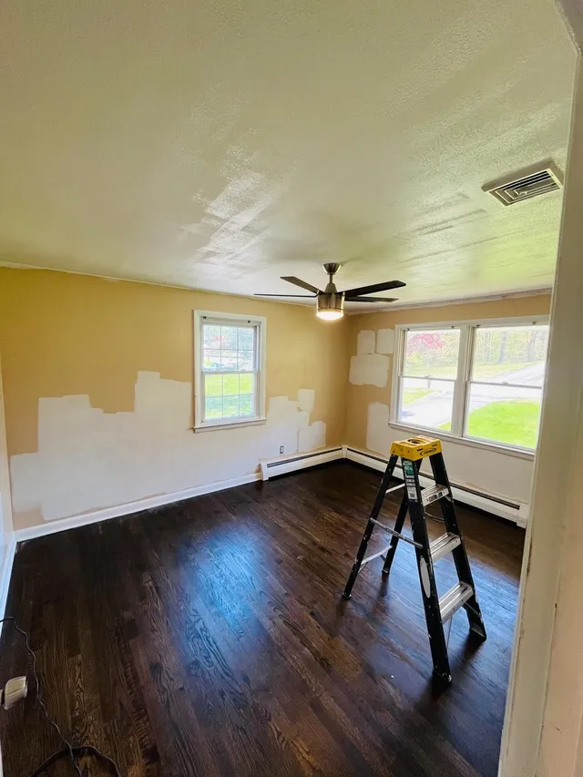 Bedroom wall repainting in progress yellow to white
