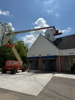 Car wash building exterior painting boom lift