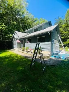 Gray blue house exterior painting ladders setup