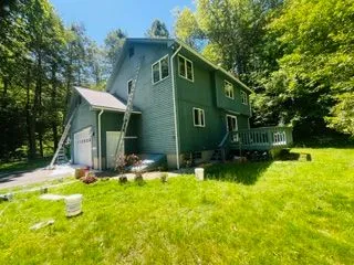 Green house exterior painting ladder and deck