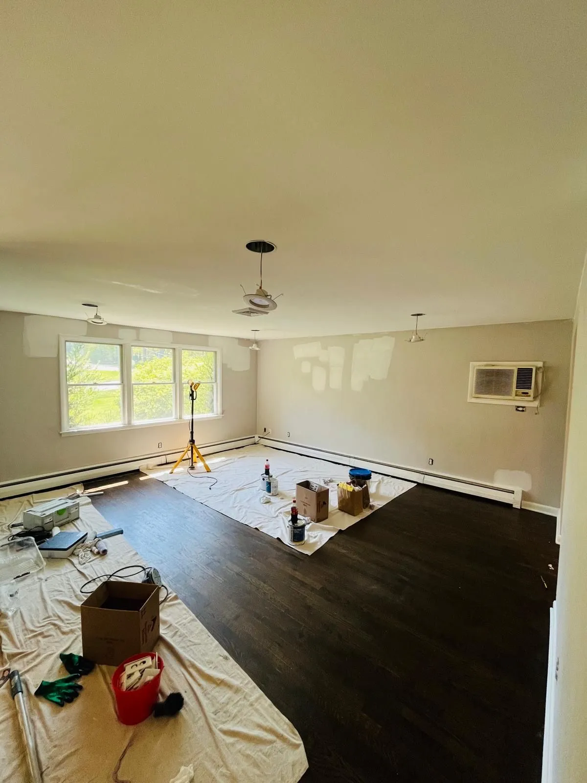 Living room wall patching drop cloths painting prep