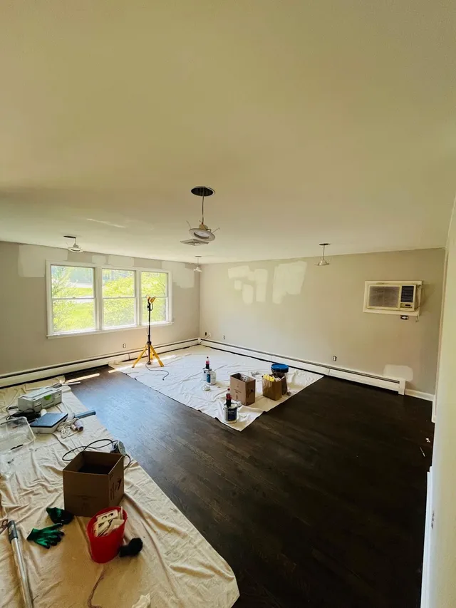 Living room wall patching drop cloths painting prep