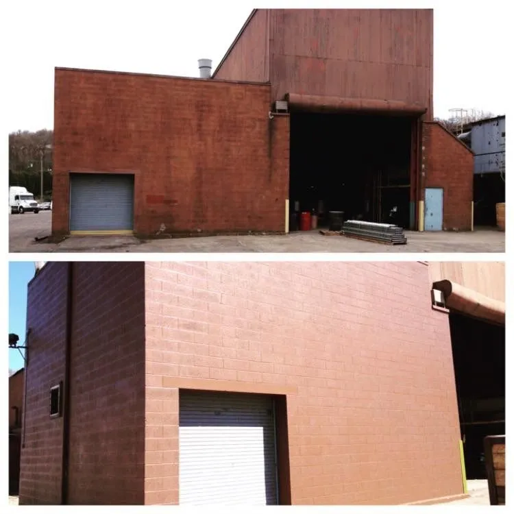 Reddish-brown industrial building with a loading bay and roll-up garage door.