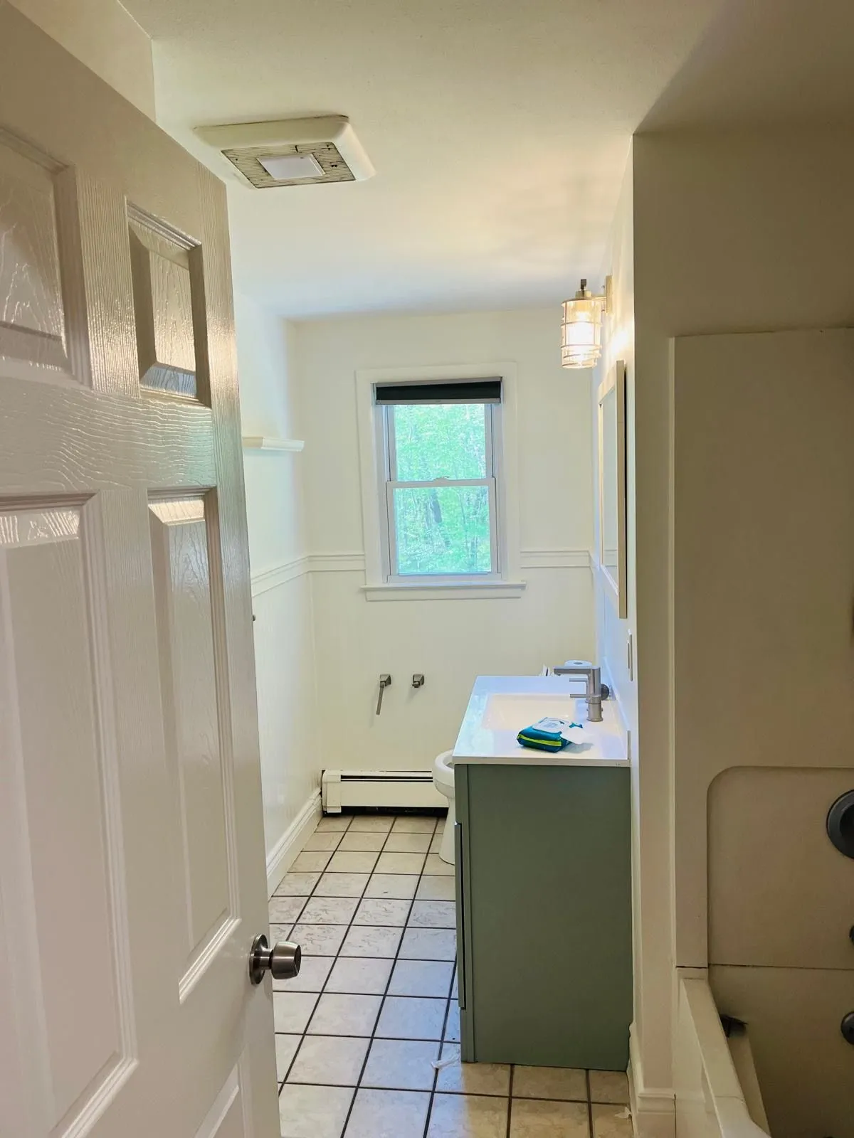 Repainted bathroom white walls green vanity
