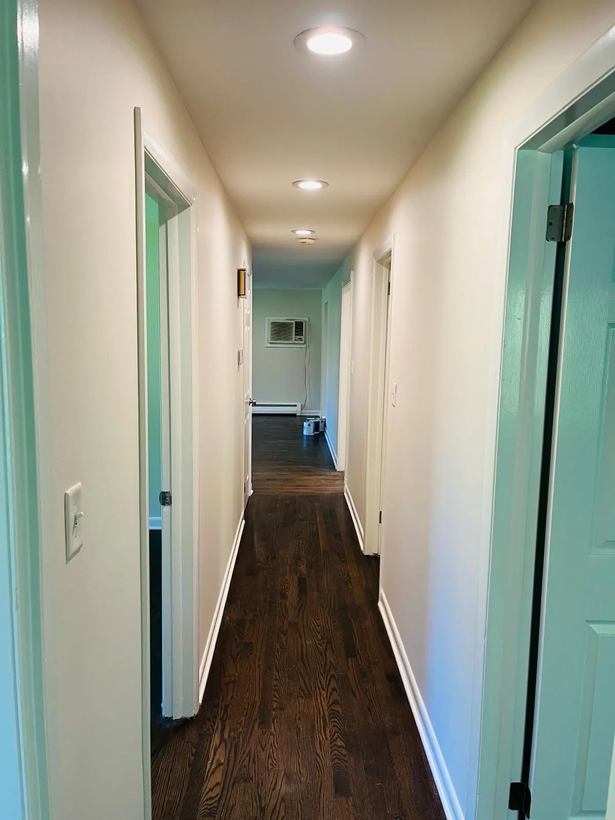 Repainted hallway white walls dark hardwood floor