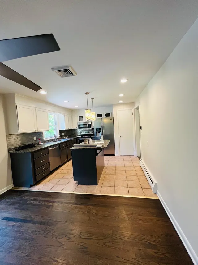 Repainted kitchen white walls dark cabinets