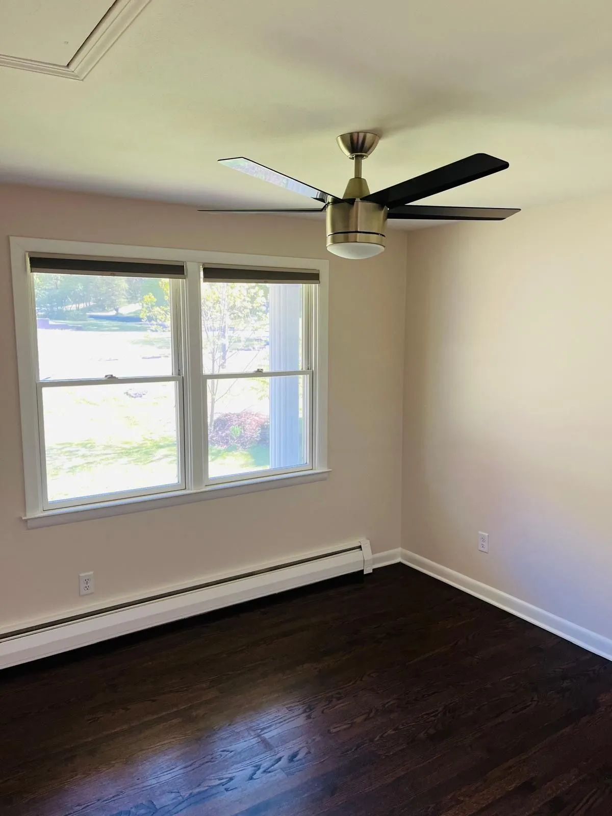 Repainted room beige walls white trim ceiling fan