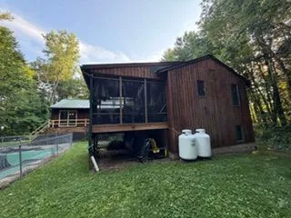 Stained wood house screened porch rear view