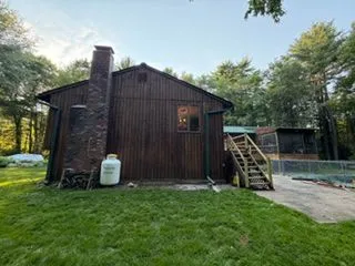 Wood sided house brick chimney after staining