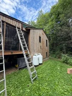 Wood sided house exterior staining with ladders
