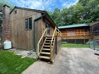 Wood sided house side entry stairs before staining